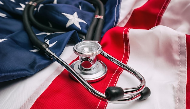 Photo a medical stethoscope on a amerian usa flag. ideal for websites and magazines layouts