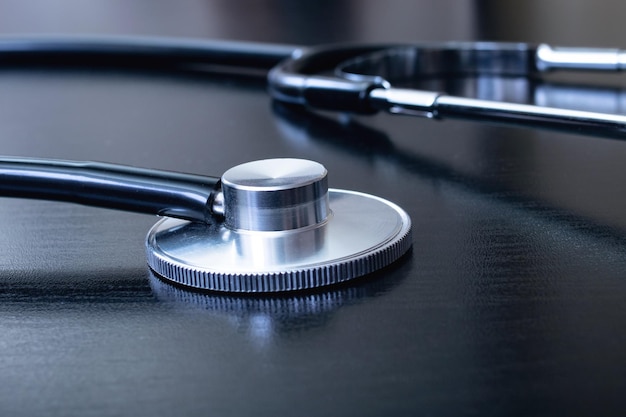 Medical stethoscope on a black table closeup