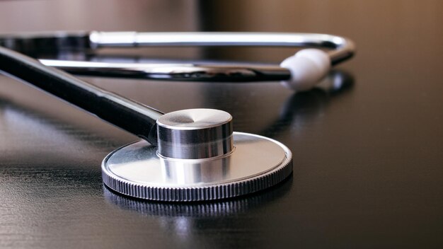 Medical stethoscope on a black table closeup