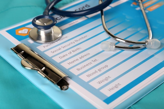 Photo medical stethoscope and clipboard on blue background