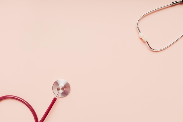 Medical stethoscope isolated on pink background with copy space Treatment and diagnostic concept