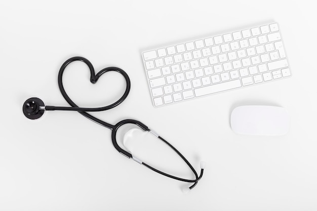 Medical stethoscope, keyboard and mouse on the desktop doctor