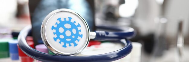 Photo medical stethoscope lying on set of vials at scientific lab