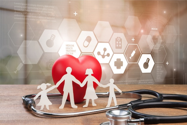 Photo medical stethoscope with heart and paper family isolated on background
