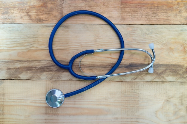 Medical stethoscope on wooden table.