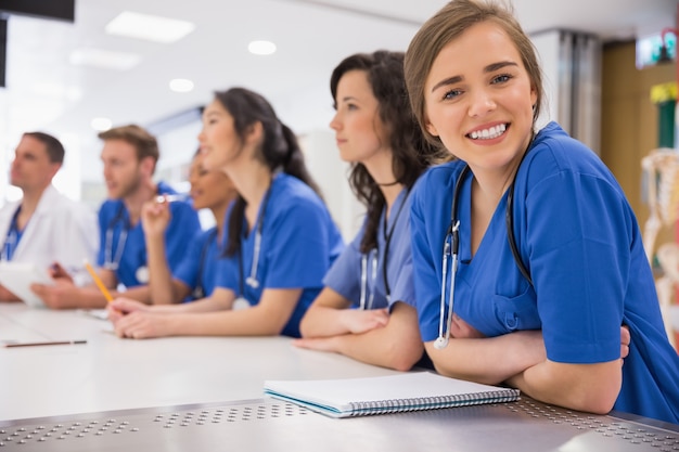 Medical student smiling at the camera during class