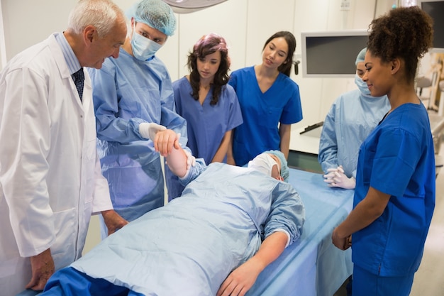 Medical students learning from professor