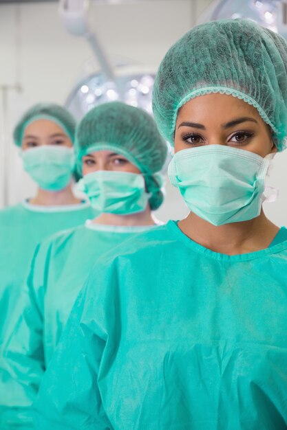 Medical students in operating theater looking at camera