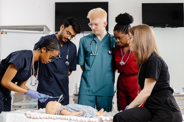 medical students practicing resuscitation on a training dummy