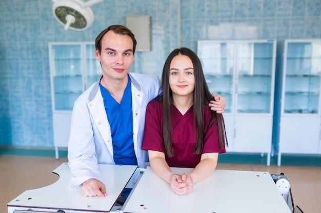 Medical students smile at the camera in the educational operating room of the medical university