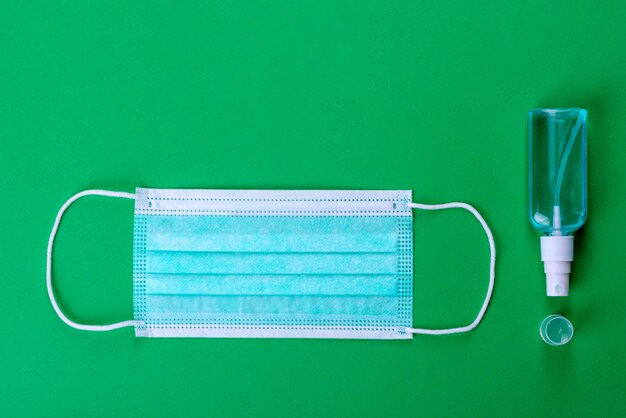 Medical supplies on green as an attribute of the fight against coronavirus. World-wide pandemic, protection