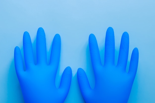 Medical supplies lie on a blue surface in the style of flat lay.