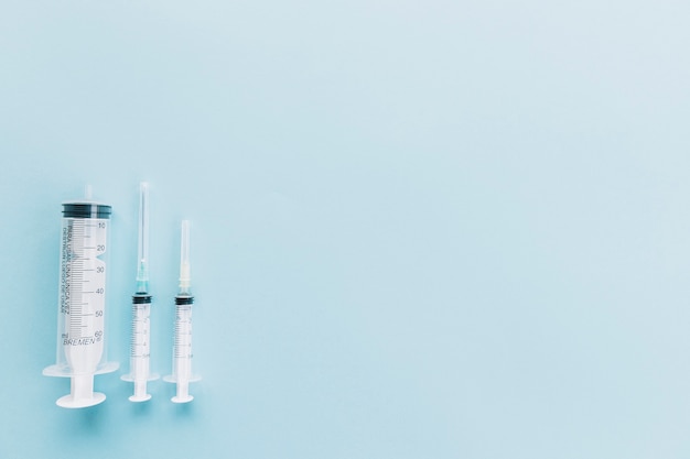 Medical syringe on blue background