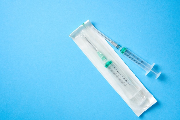 medical syringe on blue background