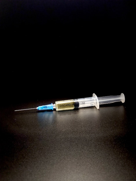 medical syringe on a dark background