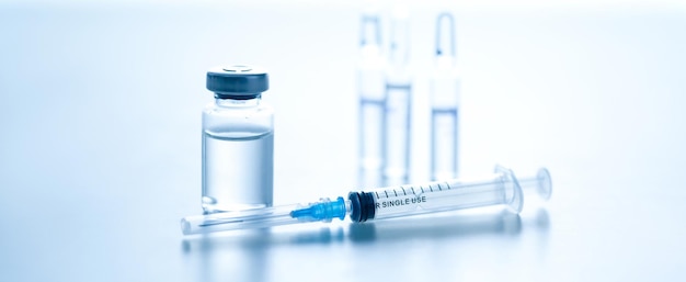 Photo medical syringe with a needle and a bollte with vaccine