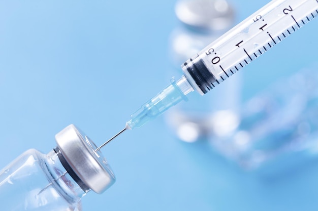 Medical syringe with a needle and a bollte with vaccine