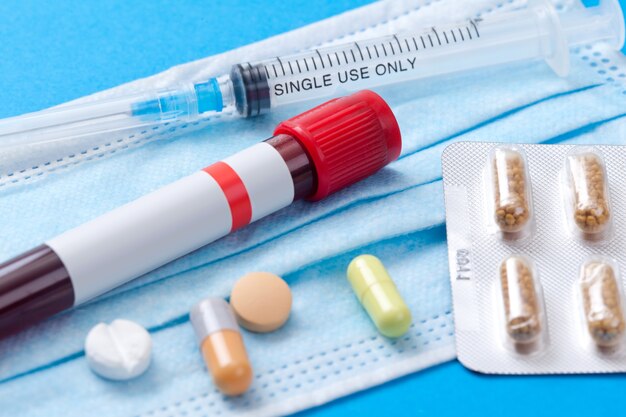 Medical syringe with a needle and pills. Corona virus vaccine.