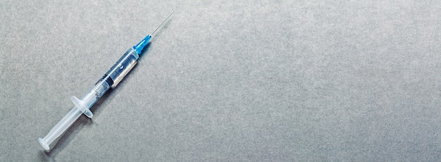 Medical syringe with a needle and vaccine against corona virus.