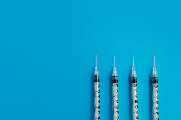 Medical syringes on blue background