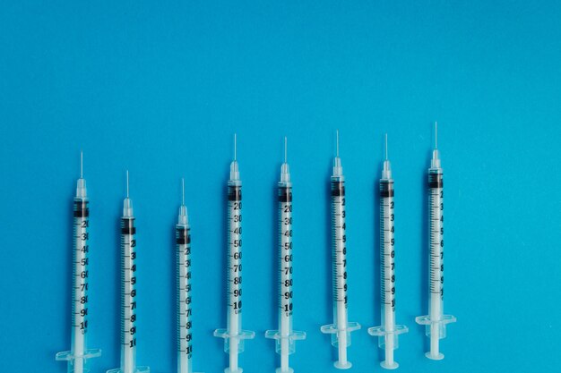 Medical syringes on blue background