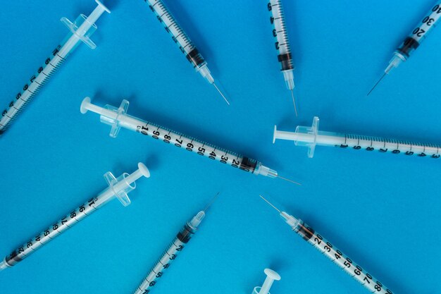 Medical syringes on blue background