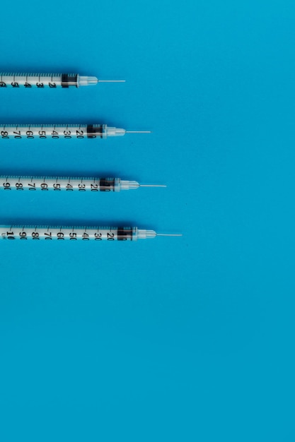 Medical syringes on blue background