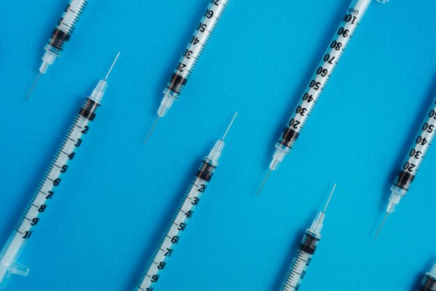 Medical syringes on blue background