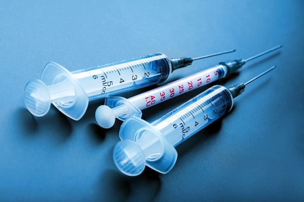 medical syringes on blue