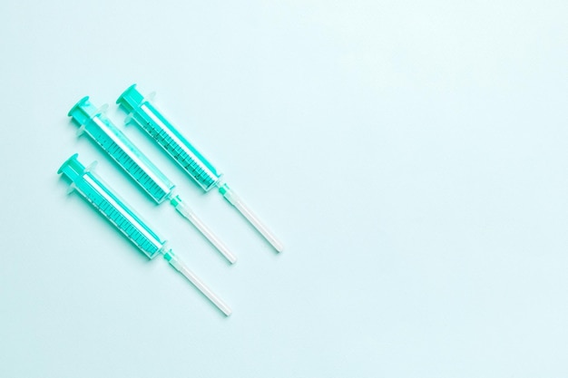 Medical syringes on a colored background top view health and medicine concept
