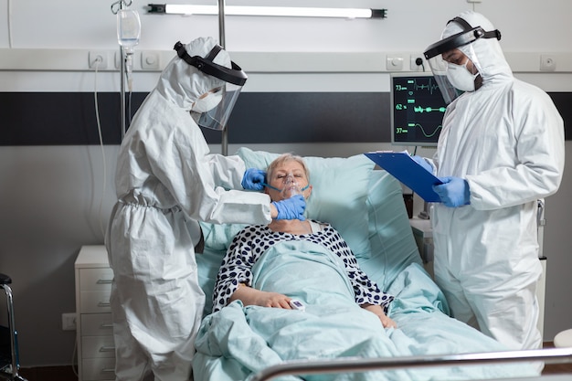 Medical team in clinic wearing coverall ppe and face shield