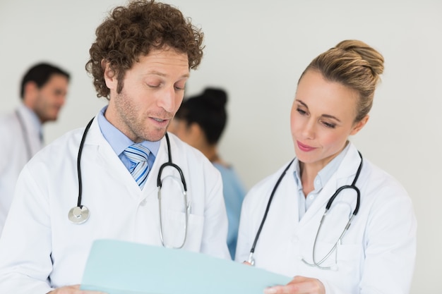 Medical team discussing over file