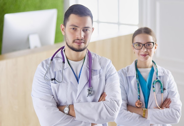 A medical team of doctors, man and woman, isolated on white background