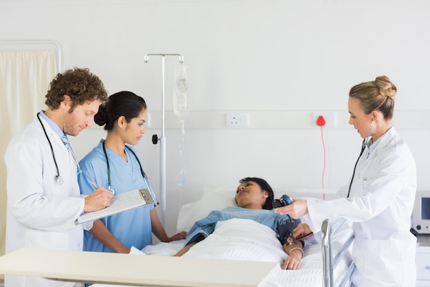 Medical team examining patient 