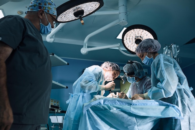 Medical team in the operating room dark background the theater of the operating room an