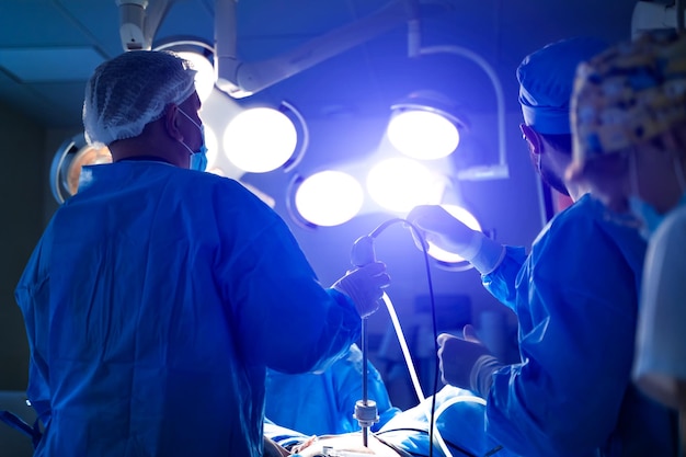 Photo medical team performing surgical operation in bright modern surgery room operating theatre modern equipment in clinic emergency room