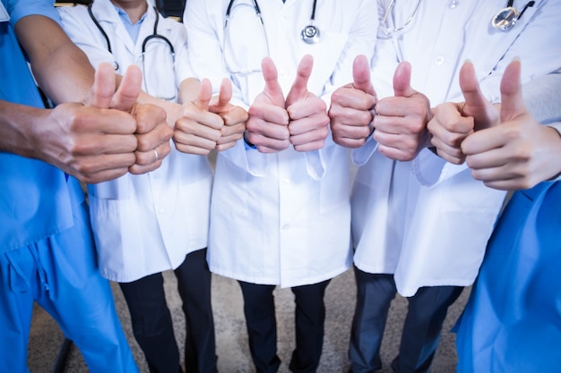 Medical team putting their thumbs up in hospital