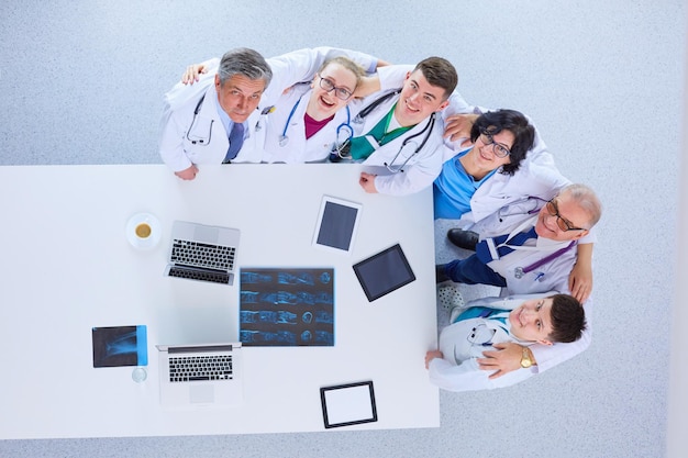 Medical team sitting and discussing at table top view