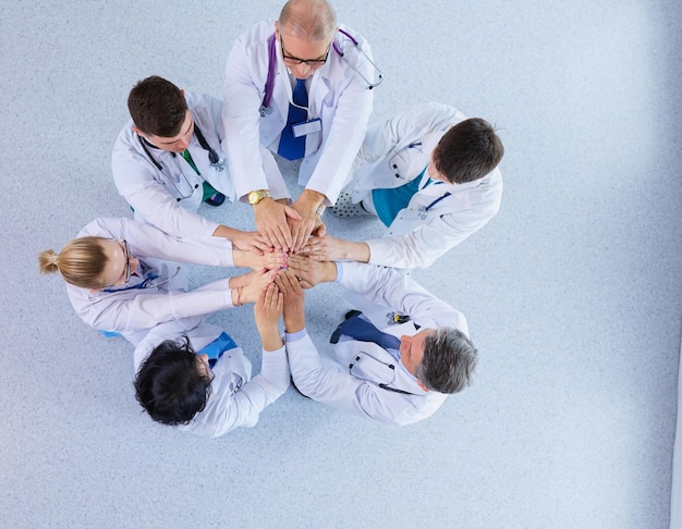 Medical team sitting and discussing at table, top view