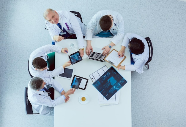 Medical team sitting and discussing at table top view