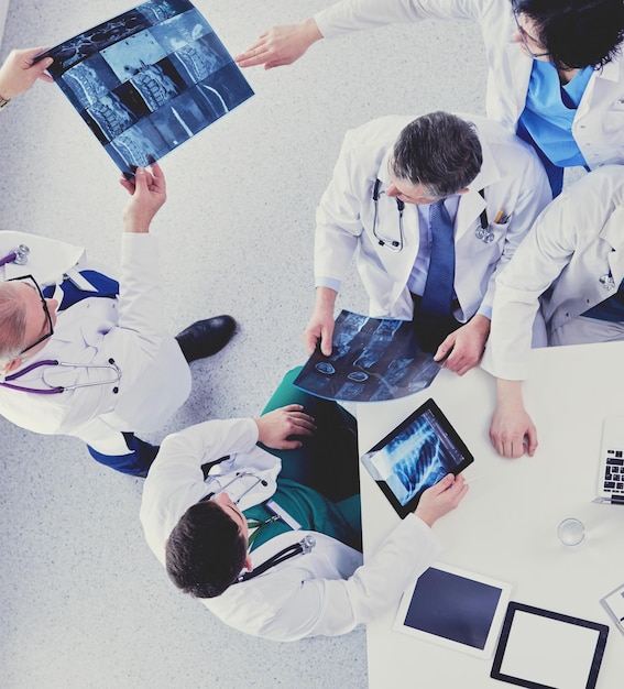 Medical team sitting and discussing at table top view