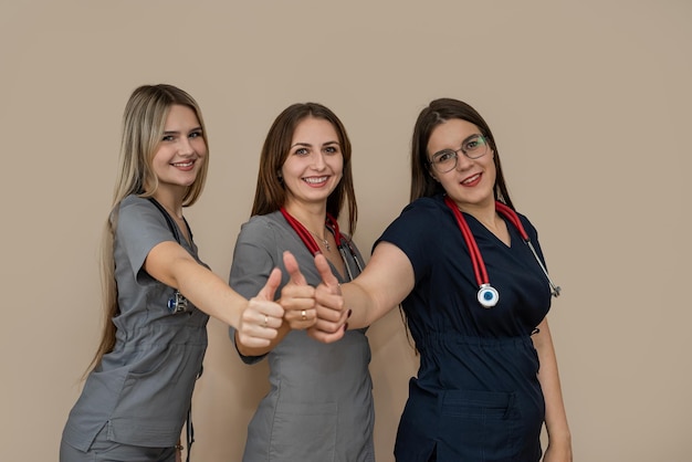 Medical team with three woman doctor standing together at isolated background