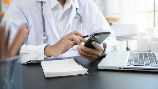 Medical Technology Concepts Medical students use mobile phones to search for information in a modern office in the morning at the desk