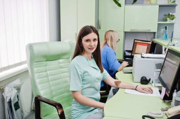 Photo medical theme. doctor sitting on chair on reception of diagnostic center in hospital.