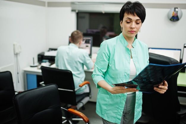 Medical theme. Female doctor hold x-ray in the mri office at diagnostic center in hospital.