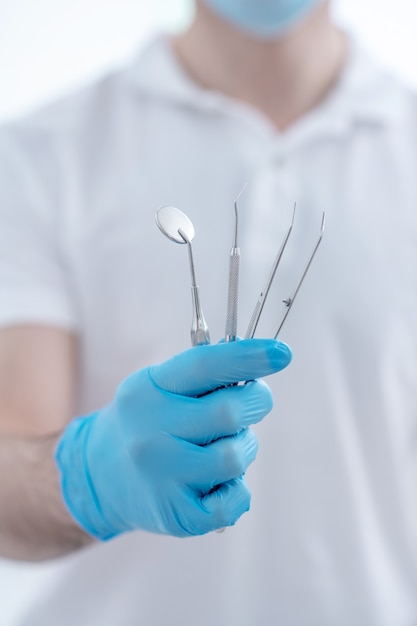 Medical tools. Close up pictire of doctors hands with dental medical tools