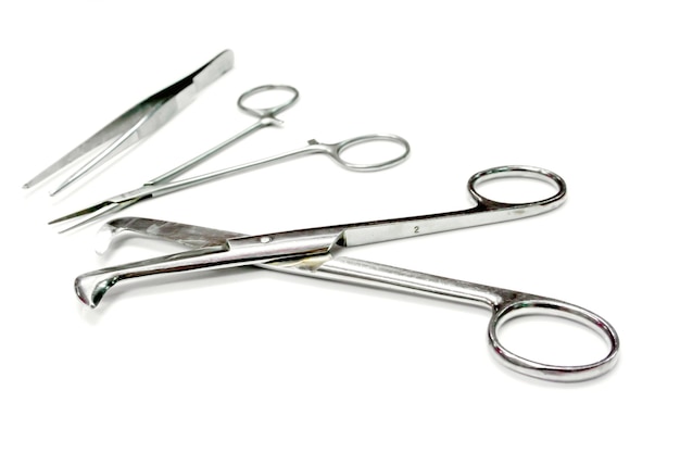 Photo medical umbilical cord scissor and medical artery clamp scissor with surgical forceps isolate on white background