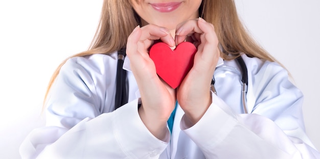 Medical woman holding a red heart