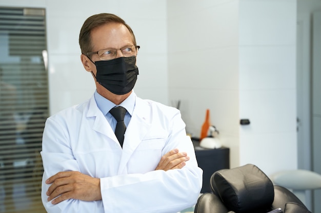 Medical worker in face mask looking to the side