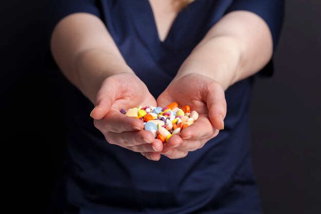 A medical worker holds in his hands the medical pills